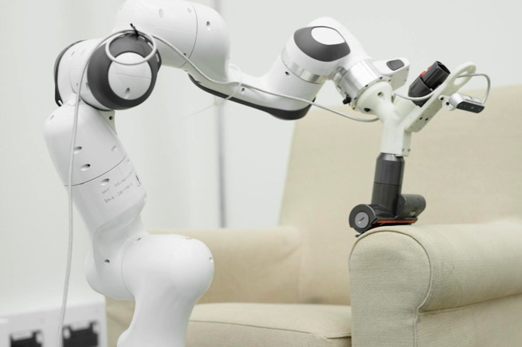 Le bras robotique Dyson aspirant un fauteuil